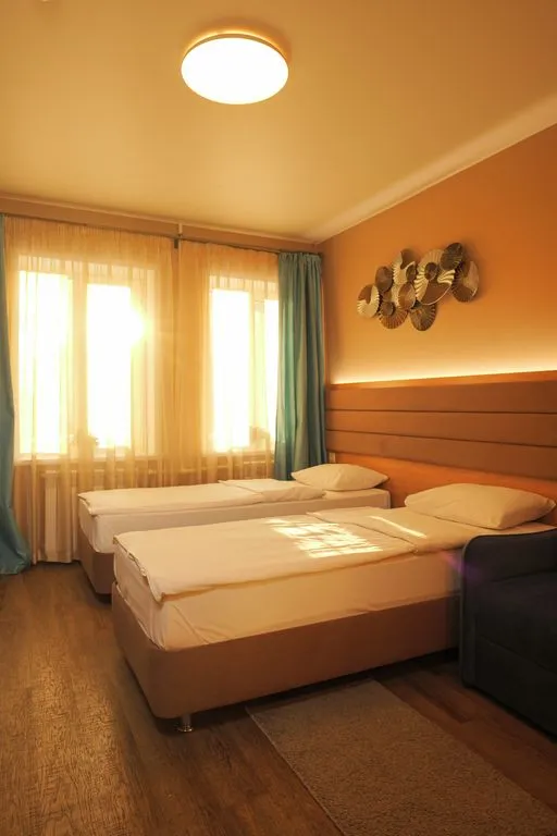 Трёхместный номер светлый с отдельными кроватями и креслом